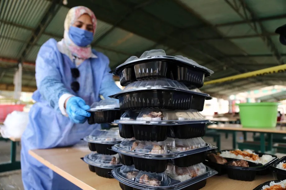 During the second Ramadan of the pandemic, community groups, like this one in Cairo, are serving iftars to-go. Xinhua/Ahmed Gomaa via Getty Images