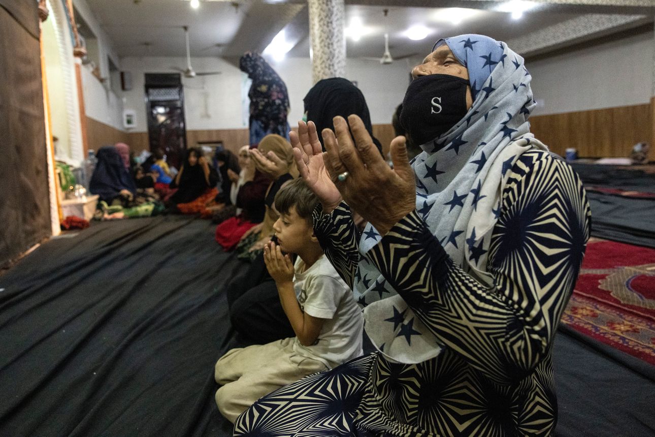 Displaced Afghan women and children pray at a mosque that is sheltering them as the Taliban advance in Kabul, Aug. 13. PHOTO: PAULA BRONSTEIN/GETTY IMAGES