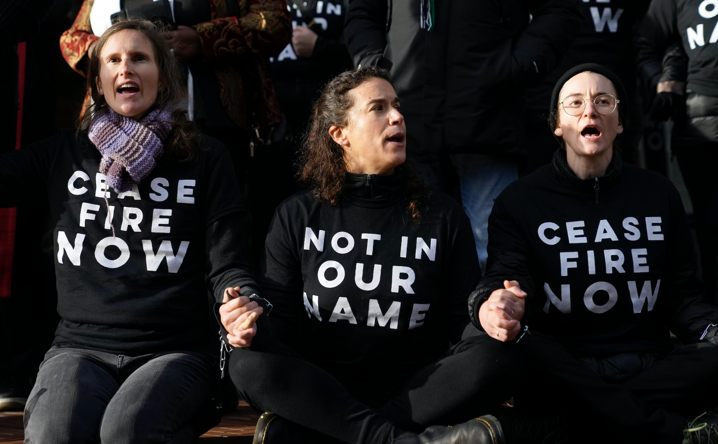 Protesters lock hands during a Jewish Voice for Peace rally outside the Henry M. Jackson Federal Building while demanding that Sen. Patty Murray, D-Wash., call for a ceasefire in the Israel-Hamas war Friday, Nov. 3, 2023, in Seattle. (AP Photo/Lindsey Wasson)